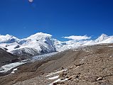 25 Shishapangma North Advanced Base Camp Next To Ice Pinnacles Of Shishapangma Glacier With Phola Gangchen, Shishapangma North Face, Yebokangjiat And Porong Ri After trekking about 7km in a little under 3 hours we reach the ridge (5790m) above Shishapangma North Advanced Base Camp. The panorama includes advanced base camp at the lower left near the ice pinnacles of the Shishapangma Glacier, Phola Gangchen on the left, Shishapangma North Face partially in the clouds in the centre, and Porong Ri on the far right. Yebokangjiat (7068m, Jebo Kangijale Peak) is the bump in the ridge just to the right of Shishapangma.